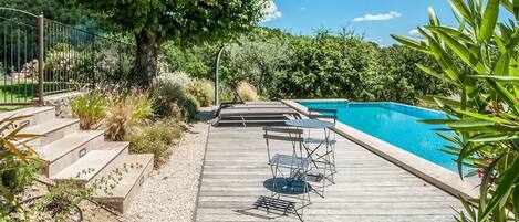 A heated pool, sun loungers
