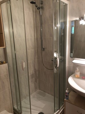 Shower, hair dryer, towels, toilet paper