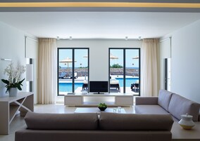 Two Bedroom Suite Swim Up Garden View | Living area | LCD TV, table tennis, books