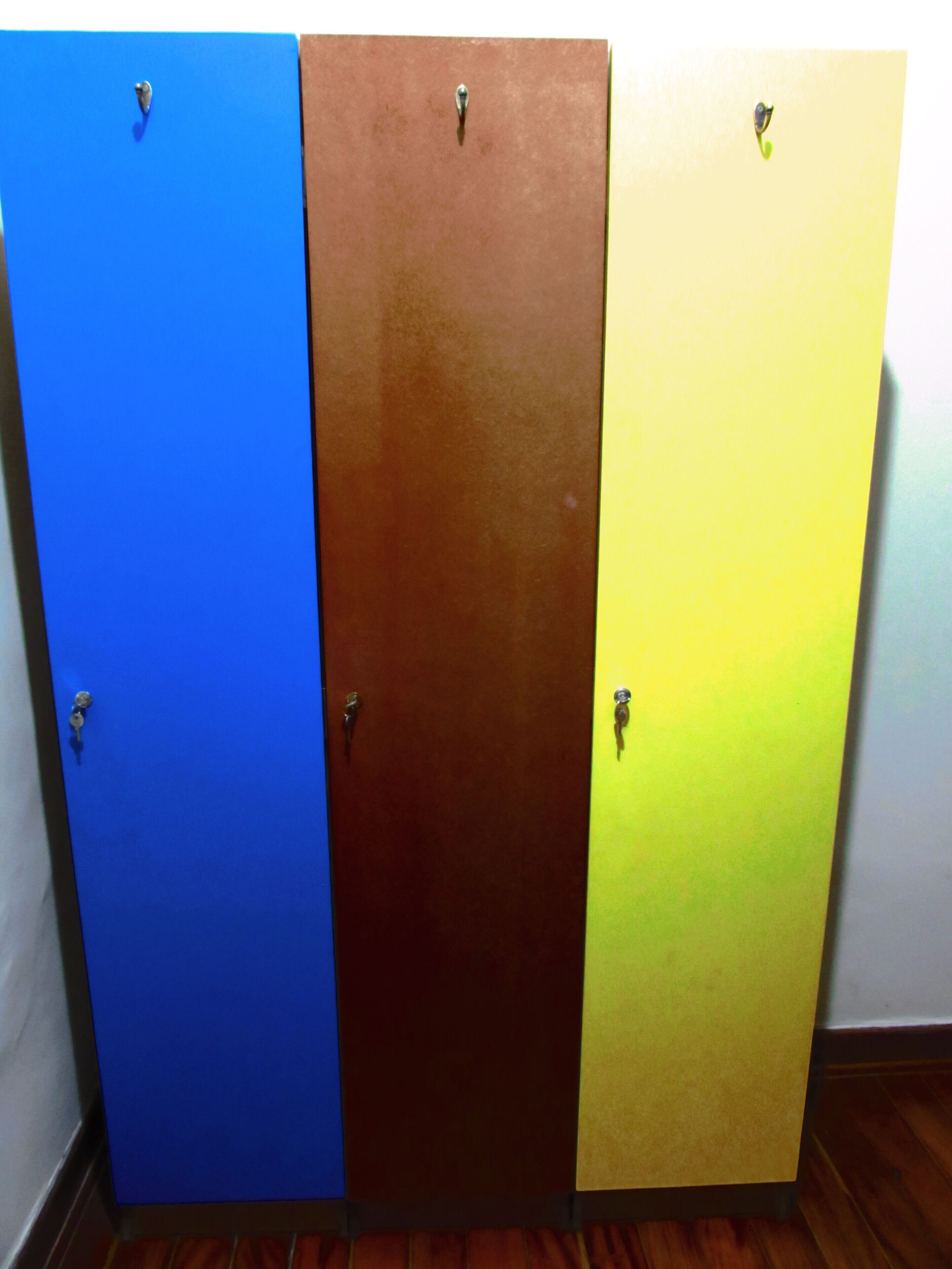Three doors in a row, each with a different color: blue, brown, and yellow.