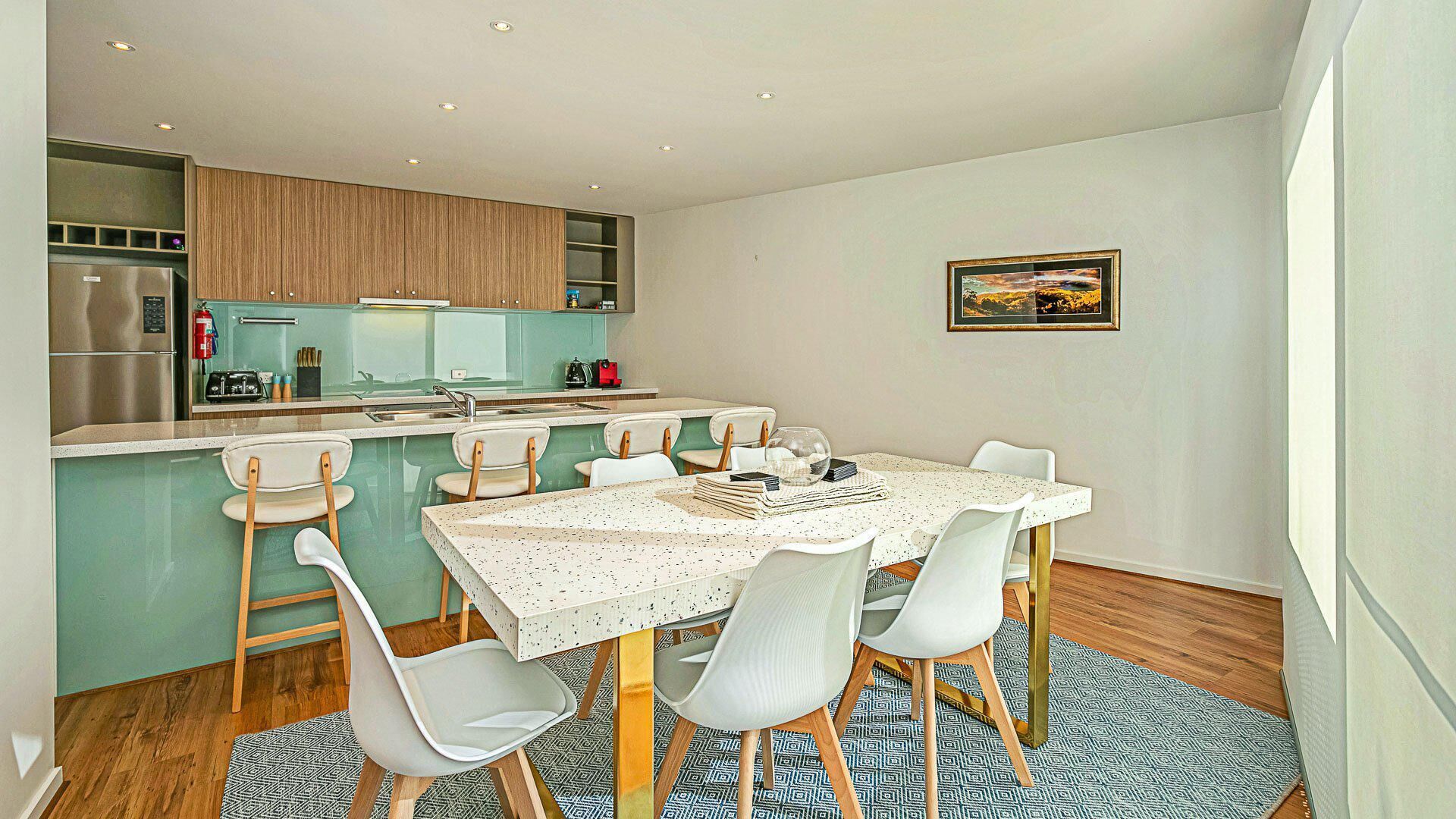 A modern kitchen with a dining area.