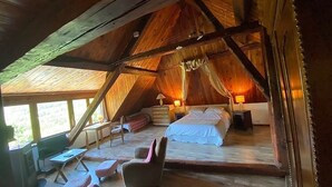 A cozy attic bedroom with a wooden ceiling, a bed, a chair, and a desk. - SUMMIT CONTINUATION (Méolans-Revel)