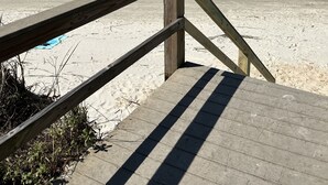 A wooden boardwalk leading to a sandy beach with a calm sea in the background. - Beachfront-Top floor, corner. Waterfront views! Smart TVs and WiFi. Sleeps 2 (Tybee Island)