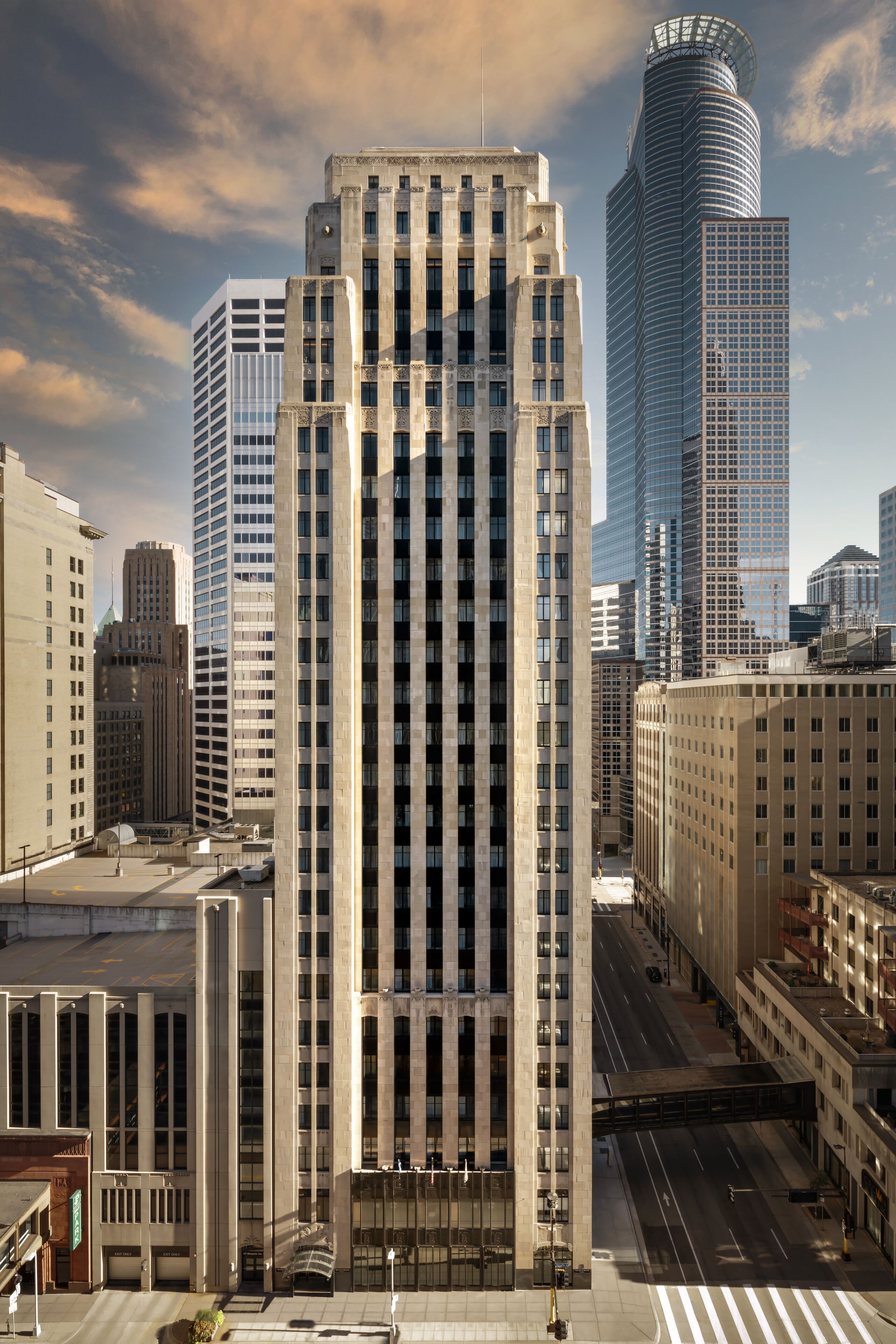 A high-rise building with a classic architectural design, featuring a central entrance and multiple floors.