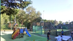 A playground with a slide, climbing structures, and a ping pong table. - Sea views and beautiful pool (Cannes)