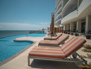 A heated pool, sun loungers
