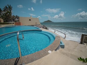A heated pool, sun loungers