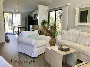 Relax in this stylish living room with two sofas, a coffee table, and a large mirror.