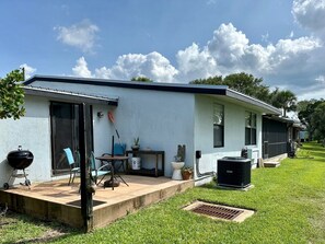 Enjoy a relaxing stay in this charming home with a covered patio, barbecue grill, and comfortable seating area.