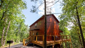A wooden cabin with a deck, surrounded by trees. - Quiet Mountain Top Family Cabin- Private, Top Location, VIEWS! (Sevierville)