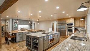 A spacious kitchen with granite countertops, stainless steel appliances, and a large island.