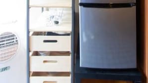 A kitchen with a refrigerator, a microwave, and a shelf with kitchenware. - Mar Vista Suite of Private Entry,Patio & Spa Bath (LOS ANGELES)