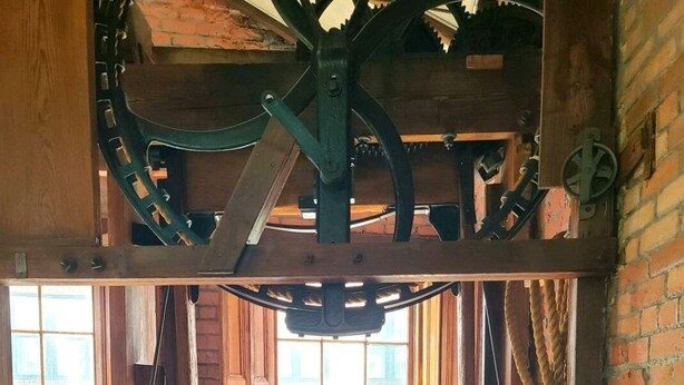 A rustic room with exposed brick walls, wooden beams, and a large window. - Downtown New Orleans Penthouse Suite - 2 Minute Walk to French Quarter -4B (New Orleans)