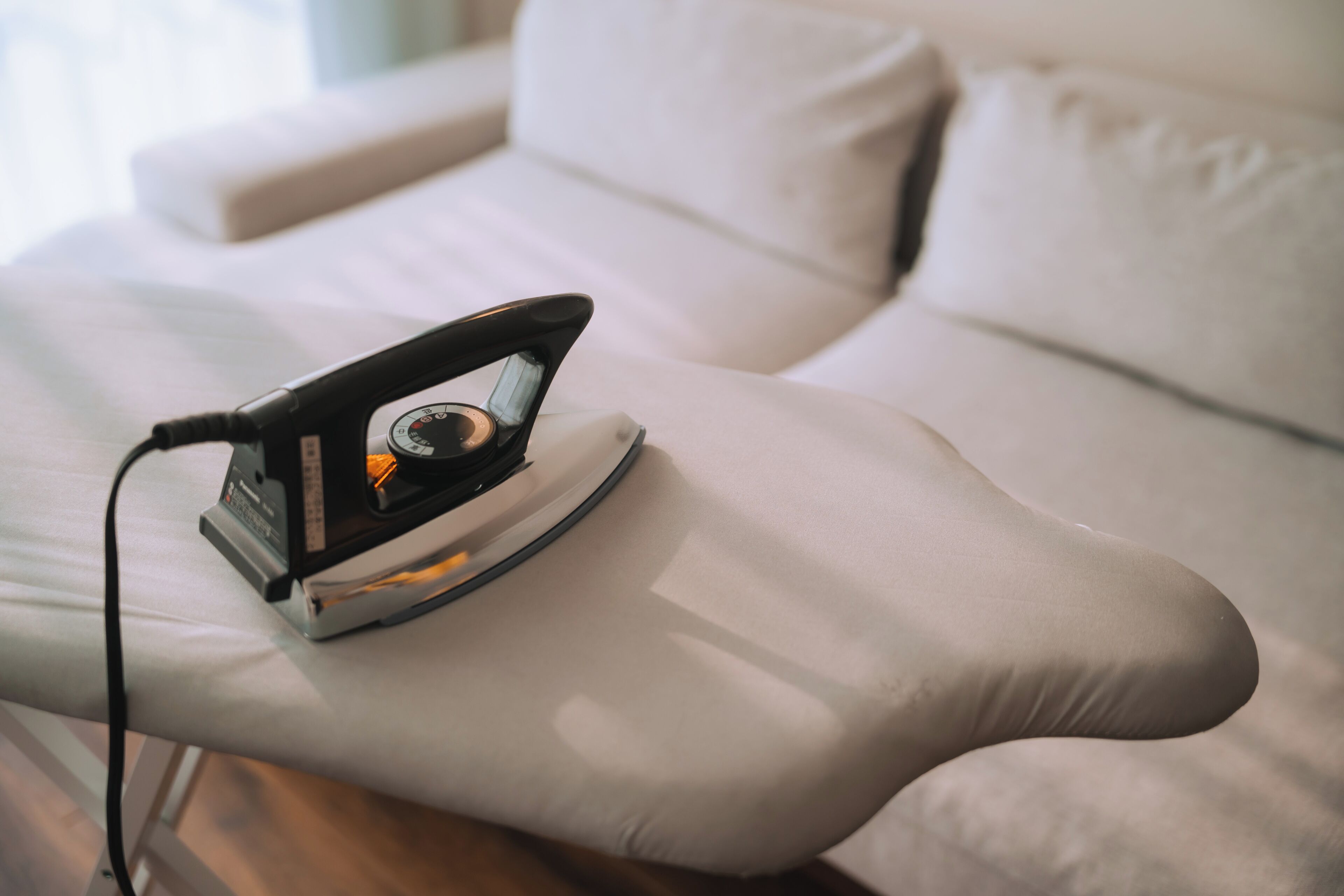An iron on a white cushion.