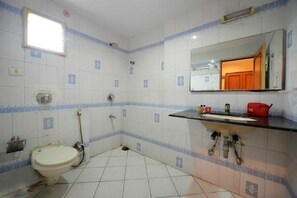 A small bathroom with a toilet, sink, and mirror.
