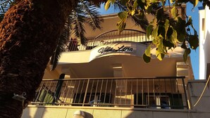 Un edificio con balcón y un letrero que dice "Villa Lena".