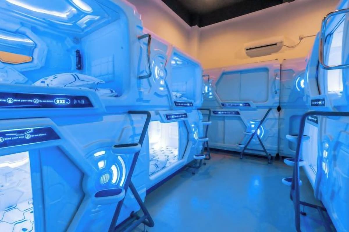 A futuristic room with a central control panel and seating areas.