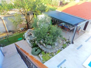 Enjoy dining or relaxing on the rooftop terrace with a garden view.