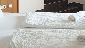 Hypo-allergenic bedding, desk, laptop workspace, blackout drapes