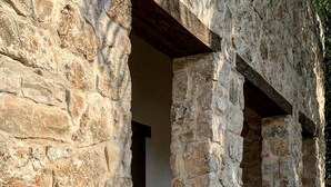 A stone building with a large pot in front. - Boutique Resort in Mayan Jungle, Solferino, Quintana Roo (Solferino)