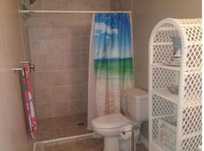 Shower, hair dryer, slippers, towels