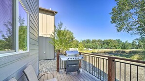 A deck with a grill, chairs, and a view of a natural landscape. - Bozeman Stand-Alone Home w/ River Access! (Bozeman)