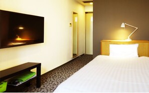 Relax in a stylish room with a flat-screen TV, comfortable bed, and convenient bedside table.