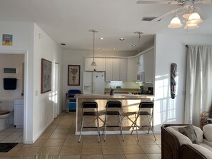 Enjoy cooking and dining in this well-equipped kitchen with a central island and adjacent living area.
