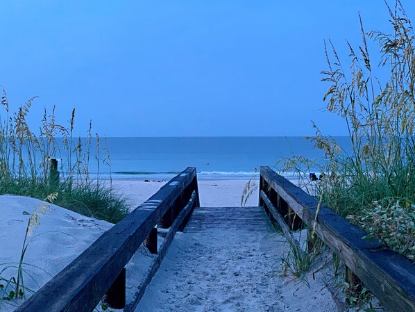 Walk along the weathered boardwalk to the sandy beach.