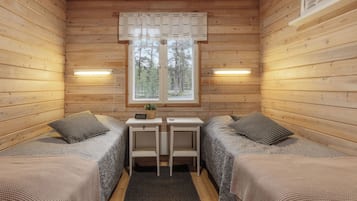 A cabin with two beds, a small table, and a window.
