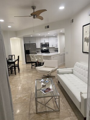 Relax in the central seating area with a comfortable sofa and coffee table, or enjoy meals at the dining table.