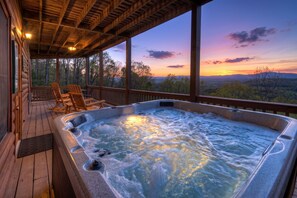 A hot tub on a wooden deck with chairs, overlooking a forested landscape. - Amazing View - Mineral Bluff (Mineral Bluff)