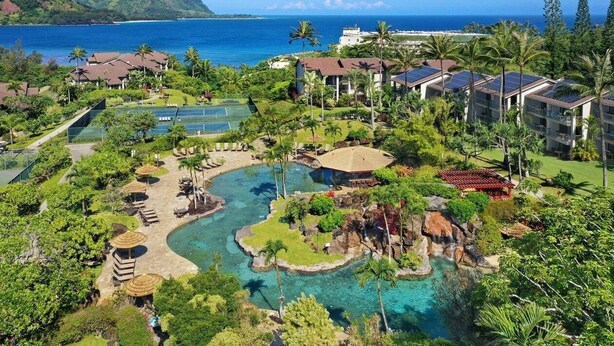 A resort with multiple swimming pools, a waterfall feature, and a view of the ocean. - Hanalei Bay Resort Suite 9304, 5, 6 (Hanalei Bay Hideaway) AC! (Princeville)