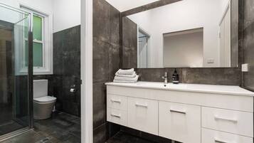 Bathtub, hair dryer, towels, shampoo