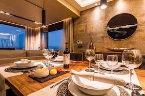 Enjoy a formal dining experience in this elegant space, complete with a dining table set for a meal.