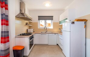 Fridge, stovetop, dishwasher, coffee/tea maker