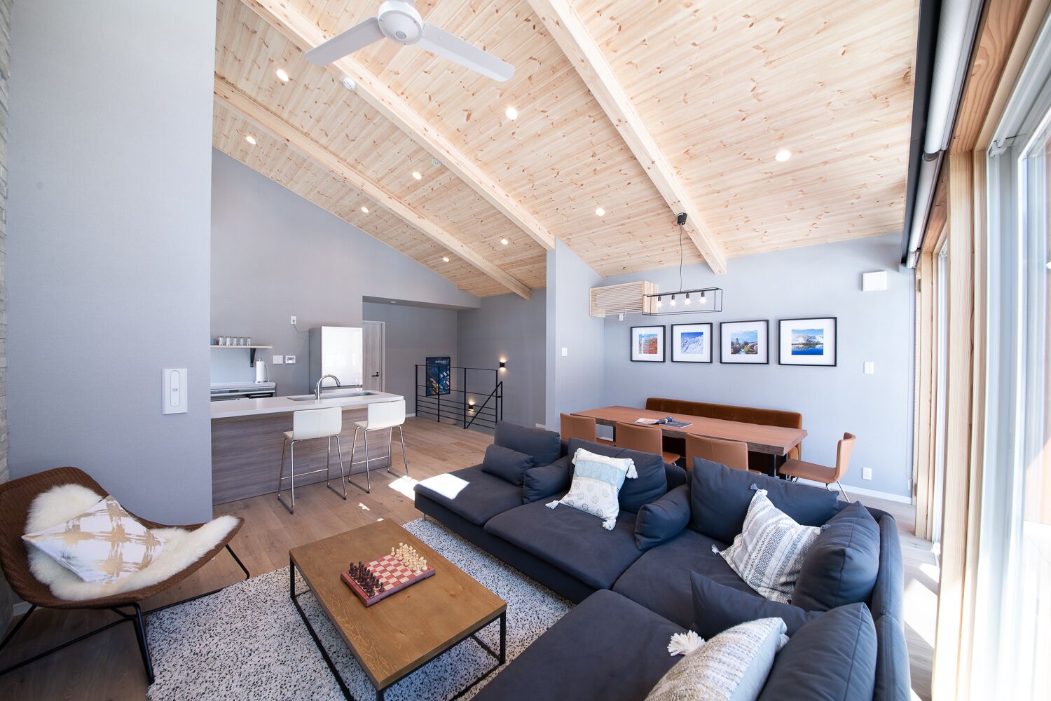 A modern living space with a kitchen, dining area, and seating area.