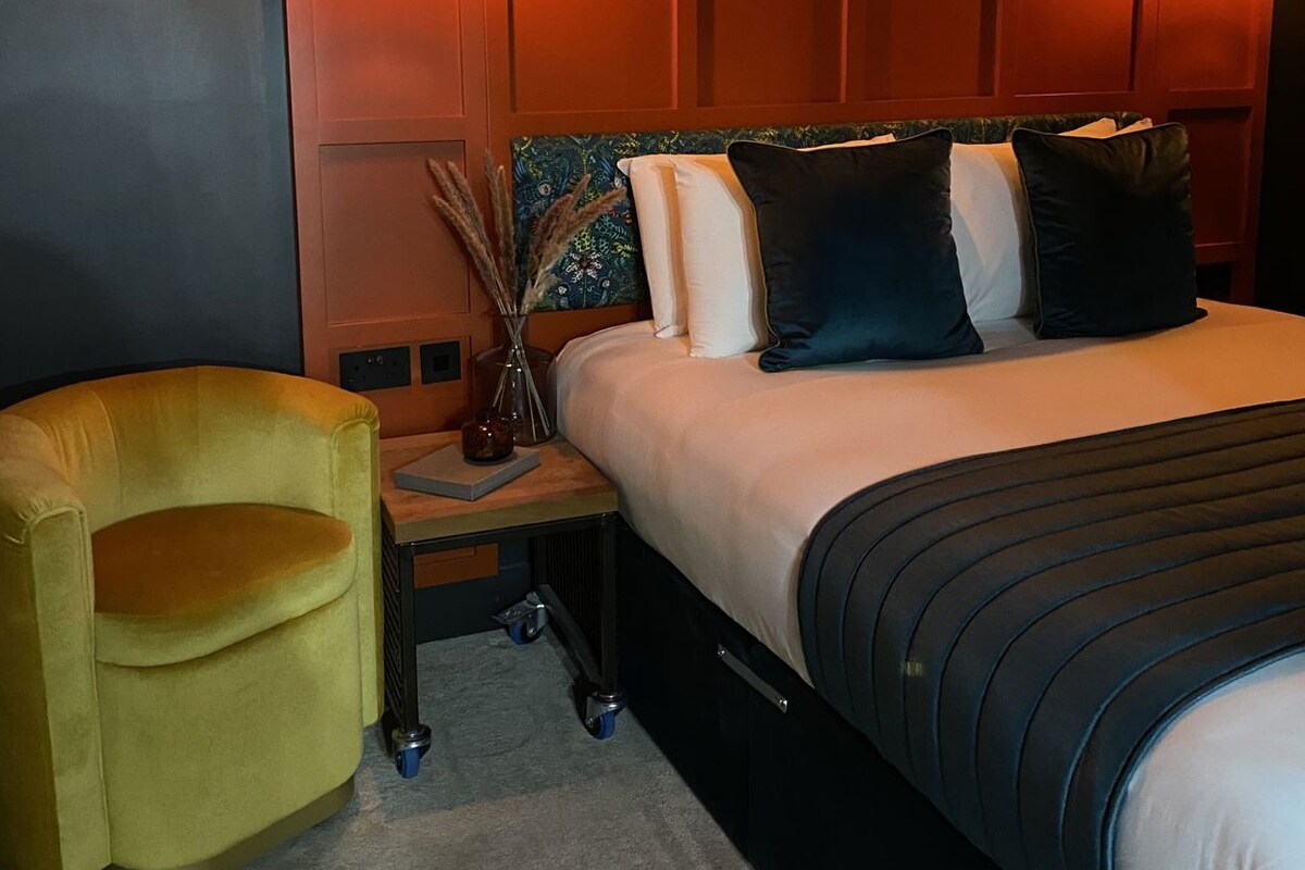Premium bedding, desk, laptop workspace, blackout drapes