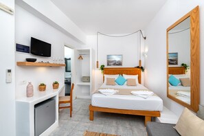 A modern bedroom with a bed, bedside table, TV, and a mirror.