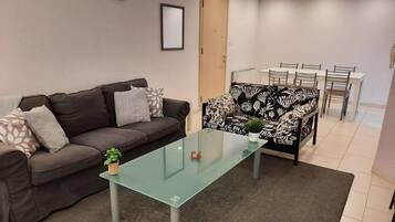 Apartment | Living area | 30-inch TV with cable channels