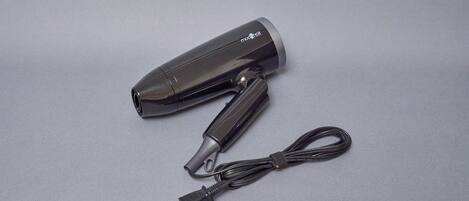 A black hair dryer with a cord and plug.