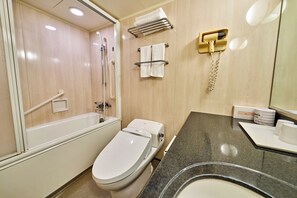 A bathroom with a bathtub, toilet, towel rack, and a hand dryer. - Smile Hotel Tokyo Nishikasai (Tokyo)