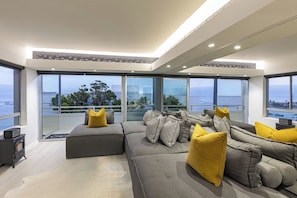 Clifton YOLO Spaces - Clifton Beachfront Executive | Living area | 55-inch TV with satellite channels, Netflix, DVD player