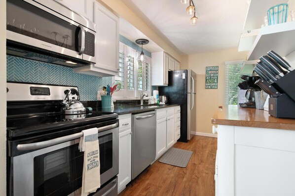 Enjoy cooking in this well-equipped kitchen with stainless steel appliances, a sink, and ample storage.