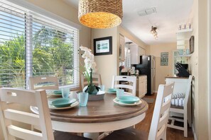 Enjoy meals together at the round dining table, surrounded by comfortable chairs.