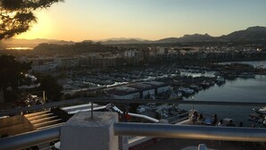 A coastal cityscape with a marina, buildings, and a sunset. - Immaculate 2-bed Villa With Pool in Mazarrón (Mazarrón)