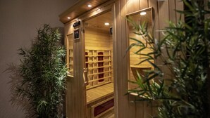 A wooden sauna with a wooden interior, a door, and a small window. - Boutique Hotel Madison  (Belgrade)
