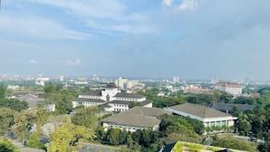 A cityscape with a mix of modern and traditional buildings, a clear sky, and a view of the surrounding urban area. - ibis Styles Bandung Grand Central (Bandung)