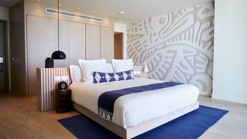 A modern bedroom with a large bed, a bedside table, a wall-mounted heater, and a decorative wall panel.