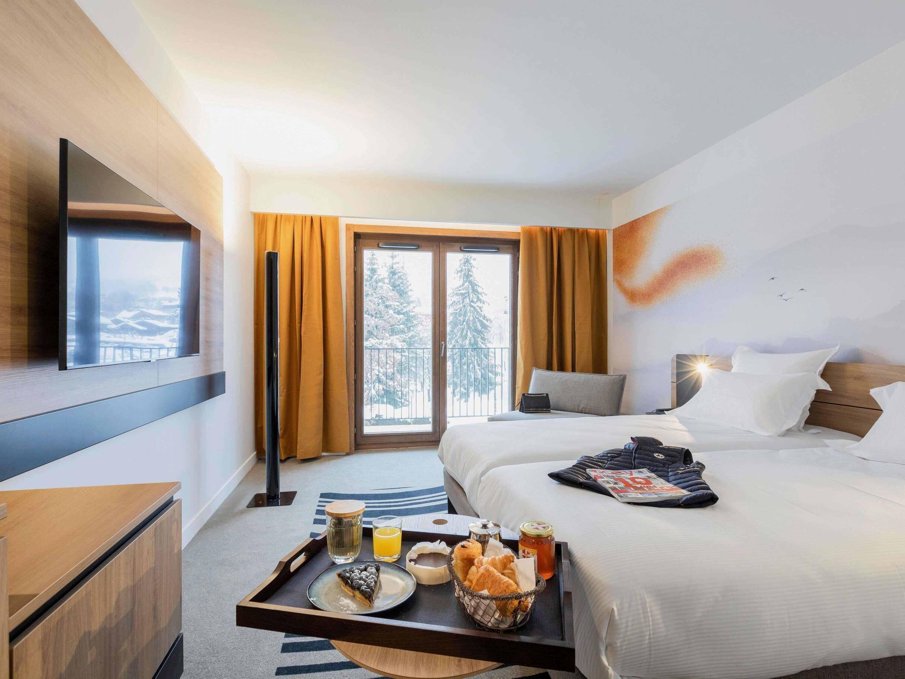 Premium bedding, laptop workspace, soundproofing, free cots/infant beds